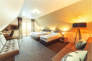 Uma cama ou camas num quarto em Hotel Zakopane Wellness & SPA ex Korona Tatr