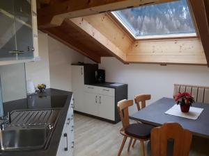 a kitchen with a table and chairs and a window at Apartment Suliva in Santa Cristina in Val Gardena