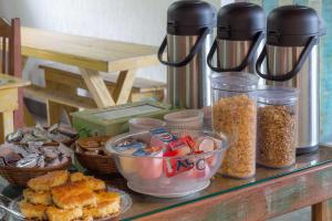 a counter topped with different types of food and condiments at Pousada Búzios Garden in Búzios