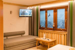 sala de estar con sofá y ventana en Das kleine Bio Hotel Tiefenbach, en Schladming