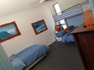 1 dormitorio con 2 literas y escritorio en Zeally Bay Stay Deep Ocean, en Torquay