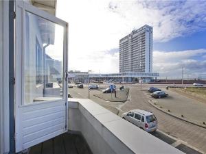 a balcony with a view of a parking lot at Zeehuis Zandvoort in Zandvoort