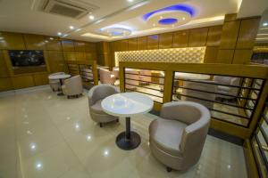 a waiting room with chairs and a table in a salon at Hotel Mira Garden in Sylhet