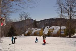 a group of people standing in the snow at Luxurious Trailside Village One Bedroom Condo #1 in Killington