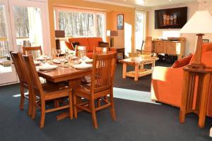 a dining room with a wooden table and chairs at Luxurious Trailside Village One Bedroom Condo #1 in Killington