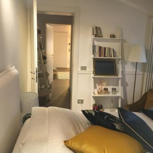 a bedroom with a white bed and a television at Papere e Tulipani in Vicenza