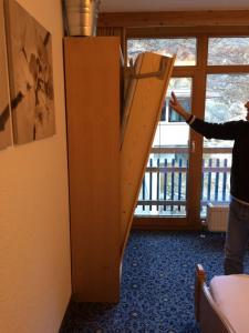 a person holding up a ladder in a room at Appartement Gurgl in Obergurgl