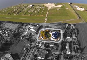 an aerial view of a city with a soccer field at Hotel Am Friesenstrand in Butjadingen