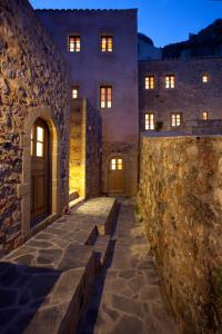 - un bâtiment en pierre avec des portes et un mur en pierre dans l'établissement Likinia Hotel, à Monemvasia