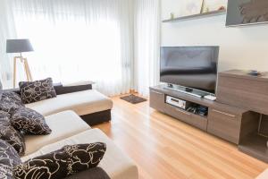 Una televisión o centro de entretenimiento en Apartamento Ria de Boo, Con patio privado