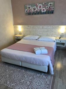 um quarto com uma cama grande e 2 almofadas em Fiumicino Airport B&B Deluxe em Fiumicino