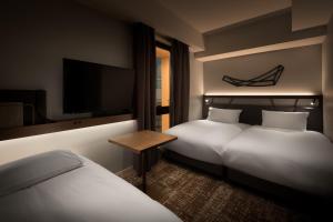 A bed or beds in a room at Nest Hotel Osaka Umeda