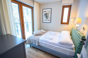 Voodi või voodid majutusasutuse Apartamenty Sun & Snow Bukowa Dolina toas