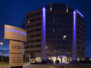 a building with blue lights on the side of it at Grand Hotel Mattei in Ravenna