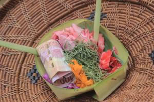 a bowl of food with a salad and a roll at Adi Bali Homestay in Uluwatu