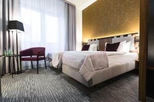 Кровать или кровати в номере Best Western Hotel Mariacki Katowice