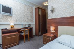 Habitación de hotel con escritorio y cama en Hotel Promien, en Skarzysko-Kamienna