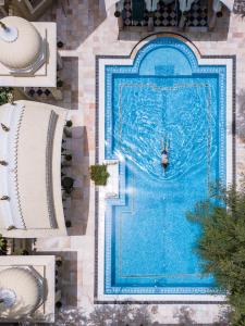 eine Person im Wasser in einem Pool in der Unterkunft Alsisar Haveli - Heritage Hotel in Jaipur