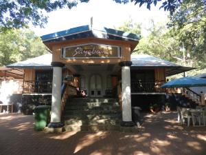 a restaurant with stairs leading up to a building at Sayeban Hotel in Matheran