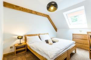 a bedroom with a bed and a window at Hotel Palatín in Oravský Podzámok