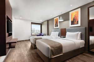 Uma cama ou camas num quarto em Howard Johnson by Wyndham, Kolkata Airport