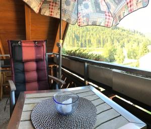 a table with a bowl on it on a balcony at Urseetalblick in Lenzkirch