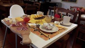 a table with cheese and other foods on it at Casa Del Noce in Rovereto