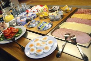 a buffet of food with meat eggs and vegetables at Steak Restaurant Penzion Country Saloon in Klatovy