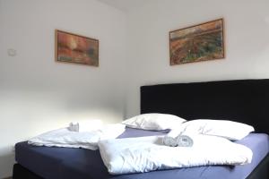 a bedroom with a bed with two pillows on it at Apartment Maya in Kranjska Gora