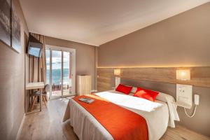 Ein Bett oder Betten in einem Zimmer der Unterkunft Hotel Montecarlo Spa & Wellness