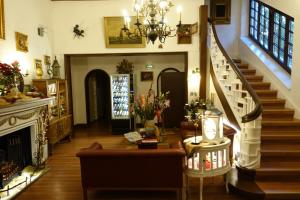 un salon avec un escalier et une cheminée dans l'établissement Hotel Villa Konstanz, à Berlin