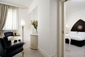 A bed or beds in a room at Palace Catania | UNA Esperienze