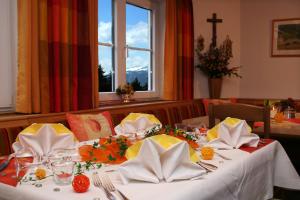 mesa de comedor con mantel blanco y cruz en Berghotel Sonnenklause, en Sonthofen