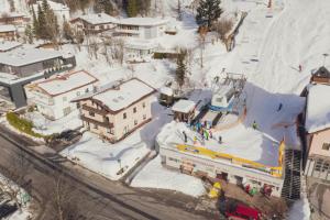 an aerial view of a snow covered city with a ski lift at Apartment NinetyFour in Annaberg im Lammertal