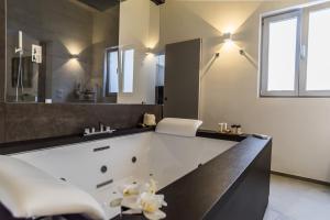 a bathroom with a large tub and a sink at Elle Suite in Lecce