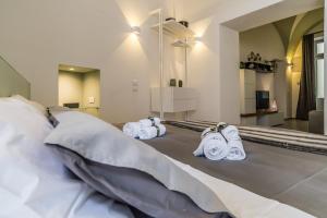 a hotel room with a bed with towels on it at Elle Suite in Lecce