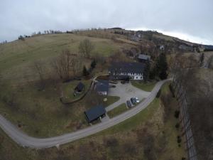 a house on a hill next to a road at Agroturystyka Łysa Góra in Jelenia Góra