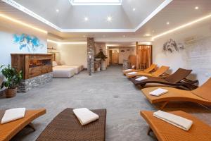 a waiting room with chairs and a fireplace at Hotel Antika in Zermatt