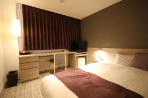 A bed or beds in a room at Kita Hotel