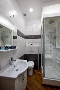 uma casa de banho com um lavatório, um chuveiro e um WC. em 360 Hospitality em Salerno