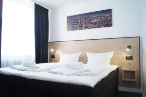 Postel nebo postele na pokoji v ubytování JJ Hotel Hannover-City-Pension