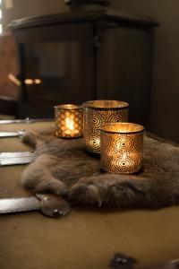 a group of three candles sitting on top of a table at Gîte de Corbion Loft1 in Ciney