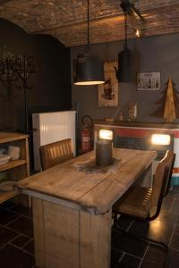 a kitchen with a large wooden table and chairs at Gîte de Corbion Loft1 in Ciney