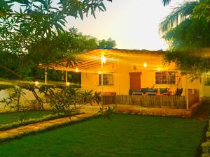 une petite maison avec une cour en face dans l'établissement West Valley Farm Villa, à Lavasa