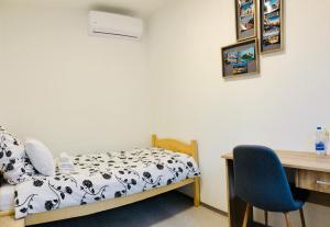 sypialnia z łóżkiem, biurkiem i krzesłem w obiekcie Lina Rooms Hostel w Lublanie