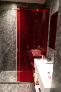 y baño con ducha de color rojo y lavamanos. en Hotel Milu Florence, en Florencia