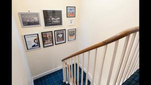 a staircase with framed pictures on the wall at The Cottage in Aberdeen