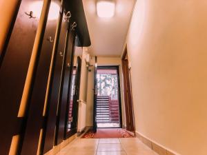 a hallway with a door leading to a stairway at Spacious Apartment near Peles in Sinaia