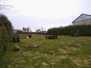 a yard with a park with a playground at Pokoje na Wiejskiej in Nałęczów