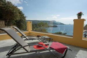 een stoel op een balkon met uitzicht op de oceaan bij Barbara's House in Paleokastritsa